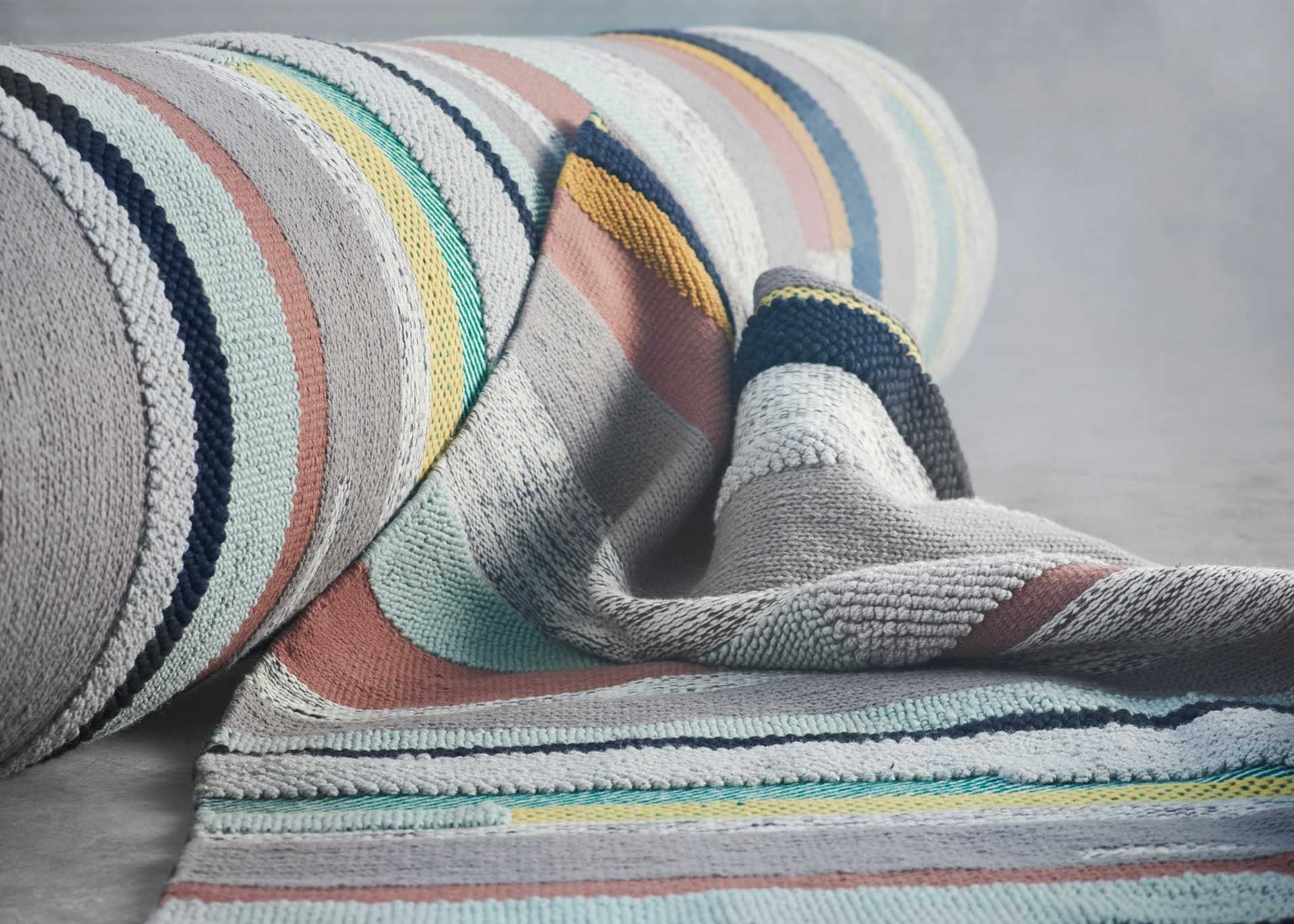 多彩な糸を使用した立体感のある手織りラグ。パッチワークのようなデザインが魅力。