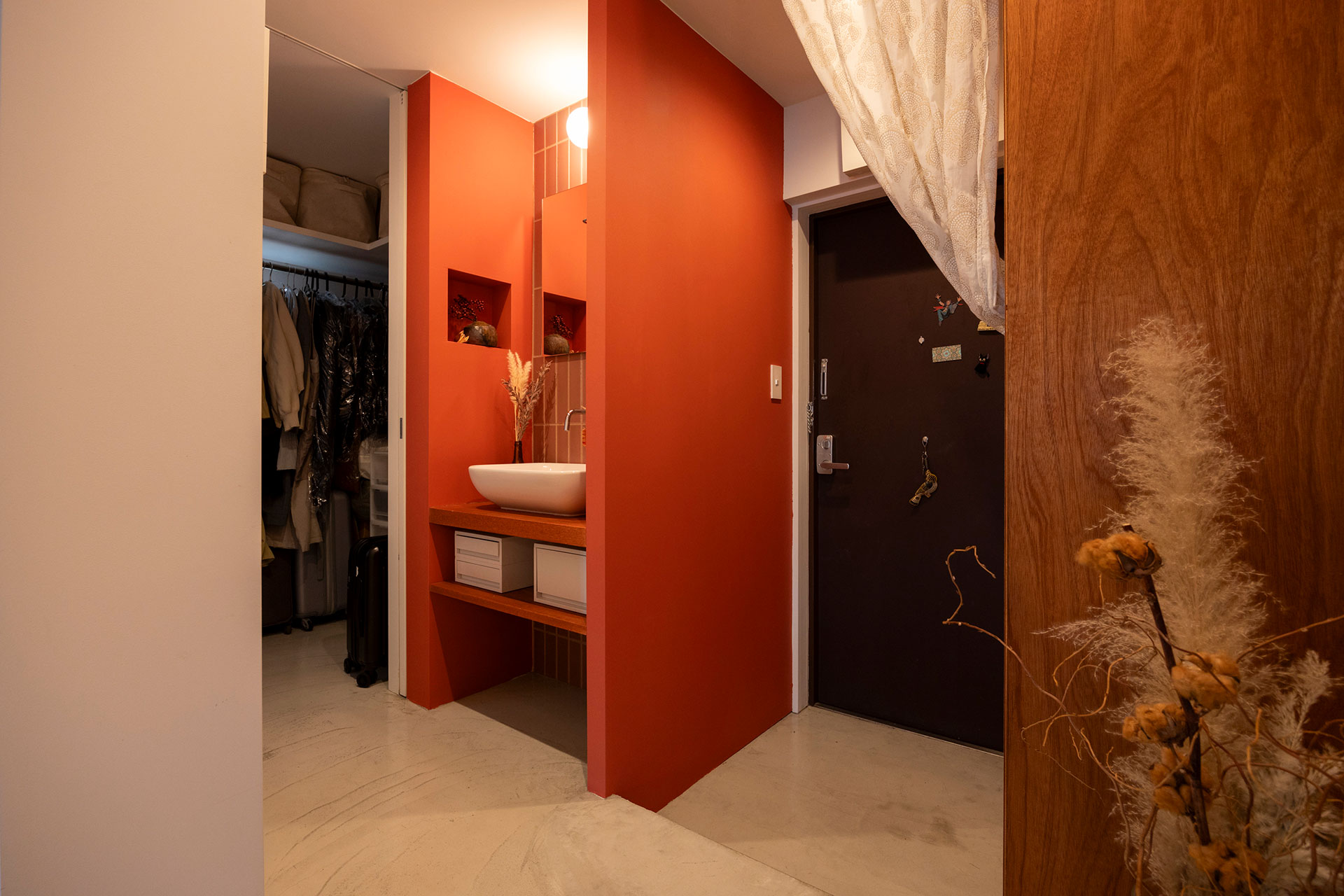 玄関脇に設けた洗面台は、来客時にも便利。まわりをレッドで塗装した。どこか中南米の雰囲気も。