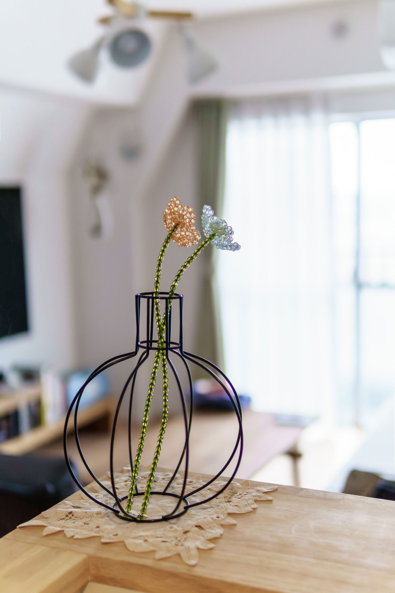 ワイヤーのフラワーベースには、ビーズでできた花を飾って。