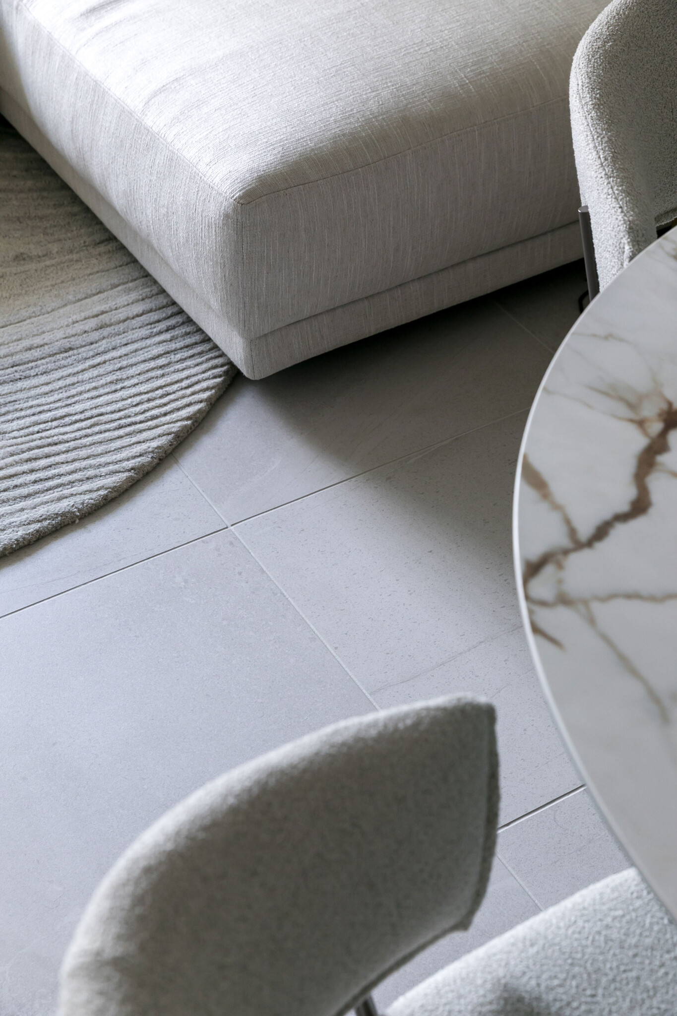 床のタイル、ラグ、ソファ、テーブル、椅子、それぞれがバランスよく調和している。